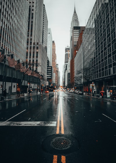 The Chrysler Building towering over a wet city street in New York City